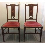 A pair of Edwardian mahogany inlaid bedroom chairs, with pink upholstered seats (2)