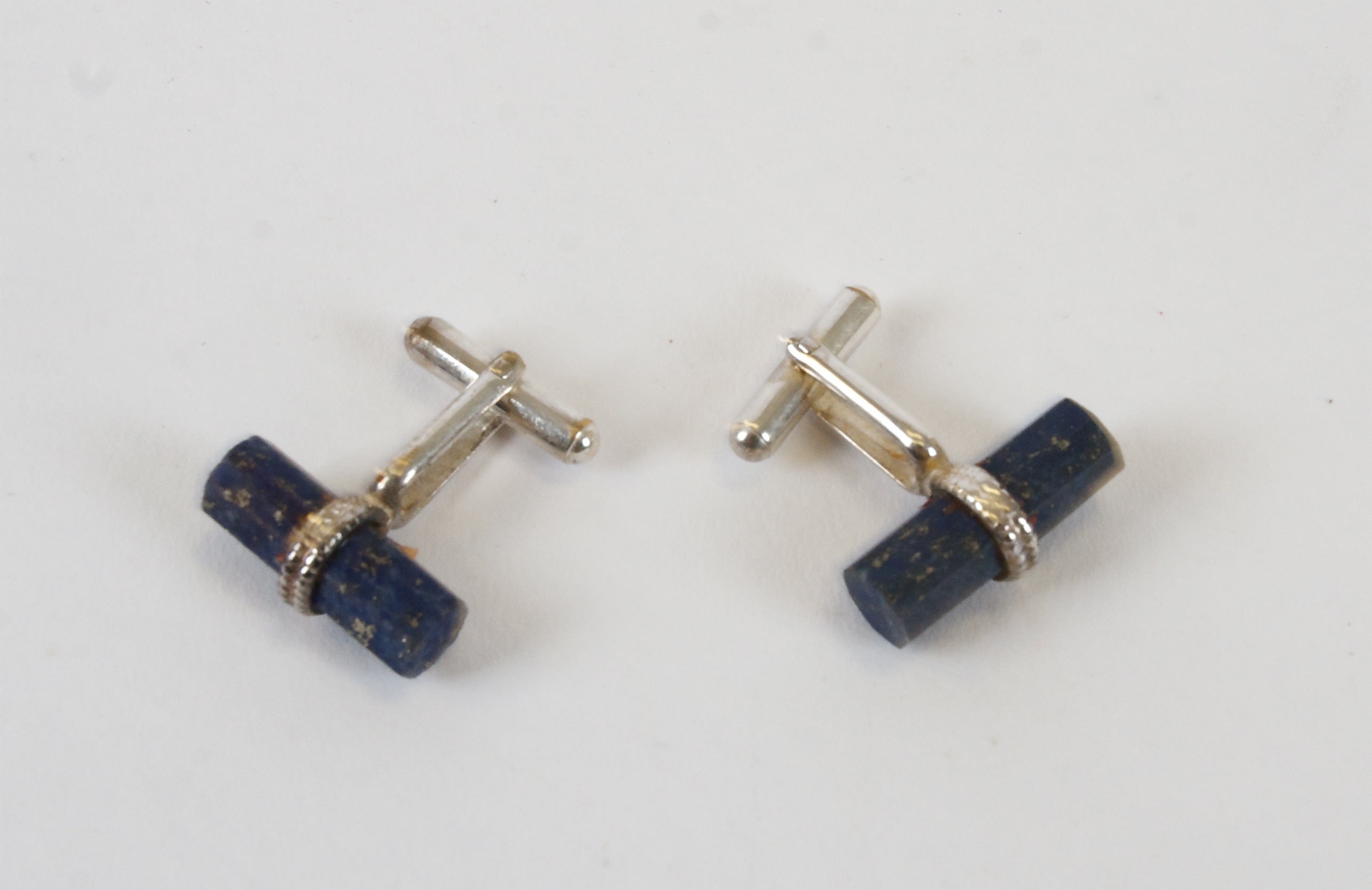 A pair of lapis lazuli and silver cufflinks, of cylindrical form