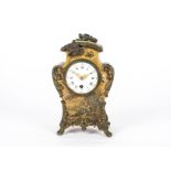 An early 20th Century French mantel clock, of curved form, decorated with painted figures and