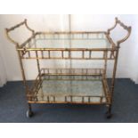 A 20th Century trolley, gilded metal faux bamboo metal trolley, with dropping glass top tier and