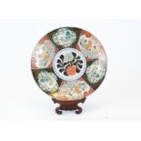 A large Japanese Imari charger, the six cartouches decorated with alternating designs of mythical