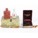 A Chinese pair of snuff containers in case, one a glass bottle with decoration of goldfish, the