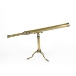 A 20th Century brass table telescope, single draw (unsigned), raised on a brass metamorphic tripod