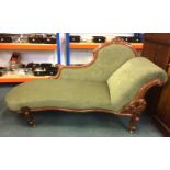 A Victorian mahogany serpentine front chaise longue, with carved showwood frame to the back,