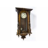 A late 19th/early 20th Century drop dial wall clock, white enamel dial with Roman numerals, in a