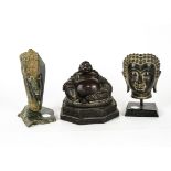 An Asian bronze bust of a Buddha, upon a square wooden base, height 19cm, together with a