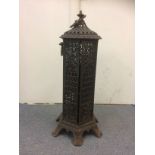 A Victorian cast iron greenhouse heater, with pierced decoration, five red coloured glass panels