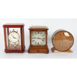 A collection of seven mantel clocks by various makers, including a Smiths retro clock, another by