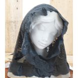 A Lladro porcelain bust of a young lady, her face shrouded in black lace, 23.5 cm tall black lace is