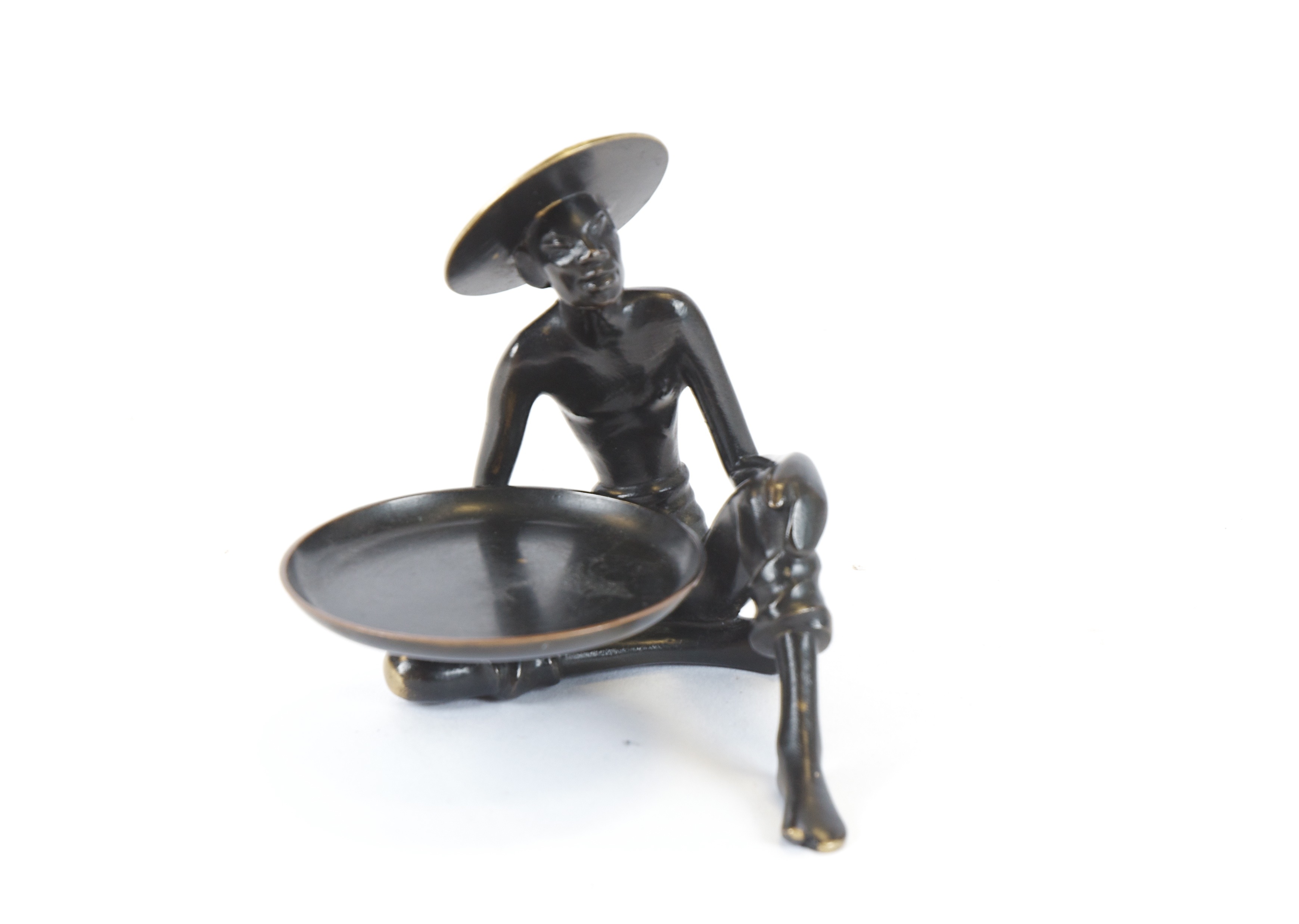 A seated Asian figure holding a tray, the base marked with two letter 'R's' one in reverse,