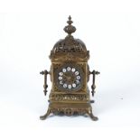 A French brass drum movement mantel clock, with enamelled roman numerals, on four splayed feet, in