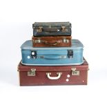 A large red vintage suitcase, approximately 71 cm x 44 cm x 22 cm, together with a blue example