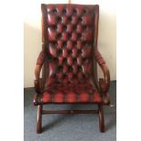A 20th Century mahogany and chestnut leather armchair, button back design, 59cm wide x 97cm high