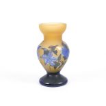 An amber coloured glass vase with blue overlaid decoration bearing a signature for Galle, the
