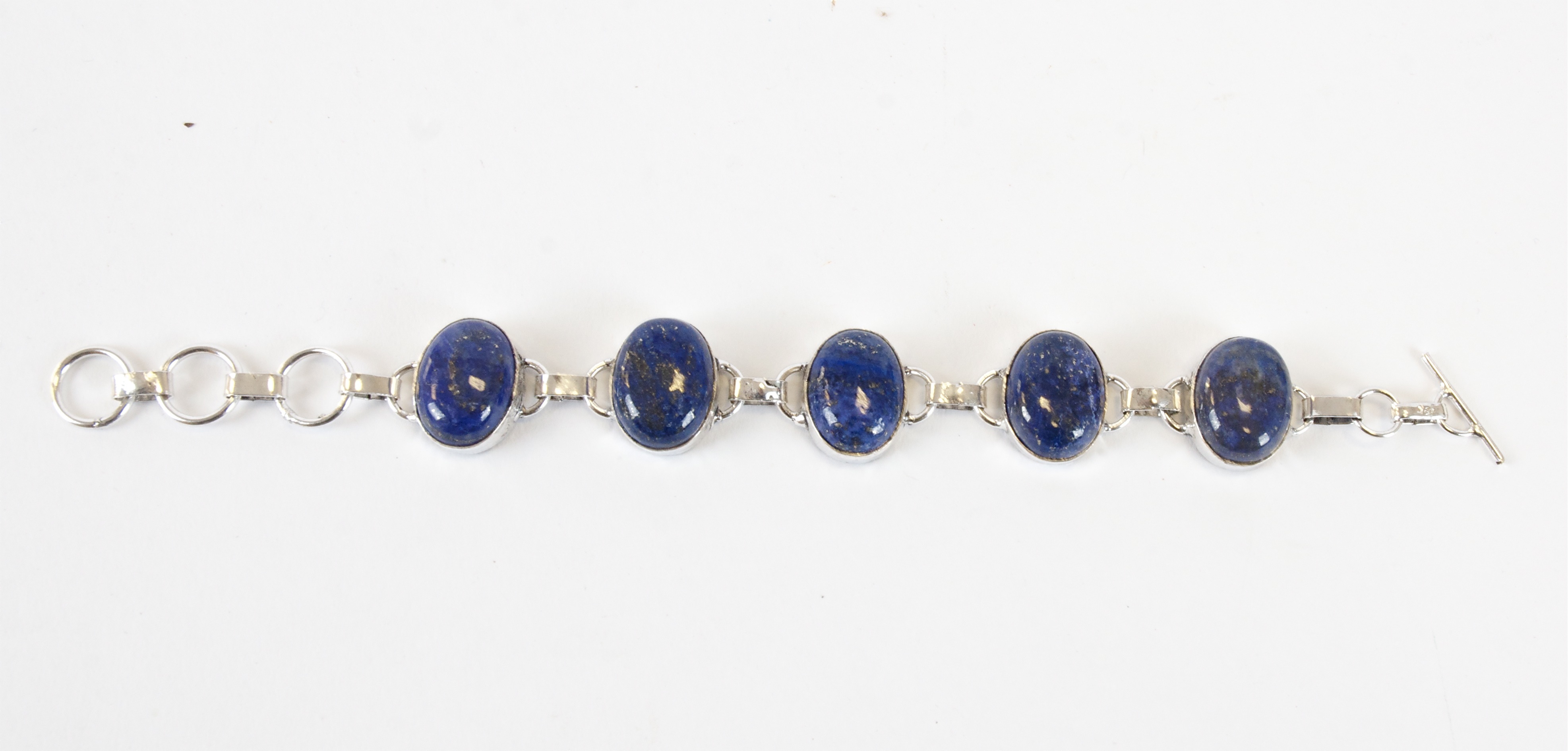A 925 silver lapis lazuli bracelet, with five oval cabochon panels
