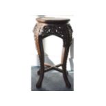 A 19th Century hardwood stand, carved with floral decoration, inset marble top and ball and claw