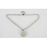 A jade necklace, the pendant in the form of a grinning Buddha, with many strung beads,