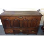 A substantial oak and elm 18th Century mule chest, four panelled front above three short drawers,