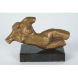 A bronze torso sculpture, in the female form and a reclining pose, raised on a marble base, with a
