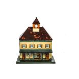 A Later Bing (BW) O Gauge 'Clock-tower' Station, in stone colour with orange-shuttered windows and