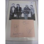 Pop Music, U2, an autographed mounted display, signed by all 4 members of the group to a large page,