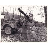 ELVIS PRESLEY Black & white 10" X 8" Press photograph showing Presley being trained with a rocket