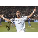 CRISTIANO RONALDO AUTOGRAPH A 12" x 8" colour photograph of Christiano Ronaldo celebrating whist