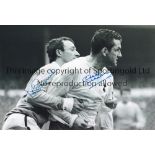 TOTTENHAM B/W 12 x 8 photo, showing an image showing Tottenham's Dave Mackay being held back by