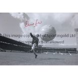 DENIS LAW B/W 12 x 8 photo, showing Denis Law striking the ball at Old Trafford during pre season