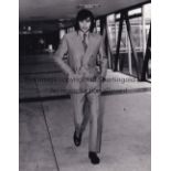 GEORGE BEST Black & white press photo dated 26/4/1970 of George Best at Heathrow Airport leaving for