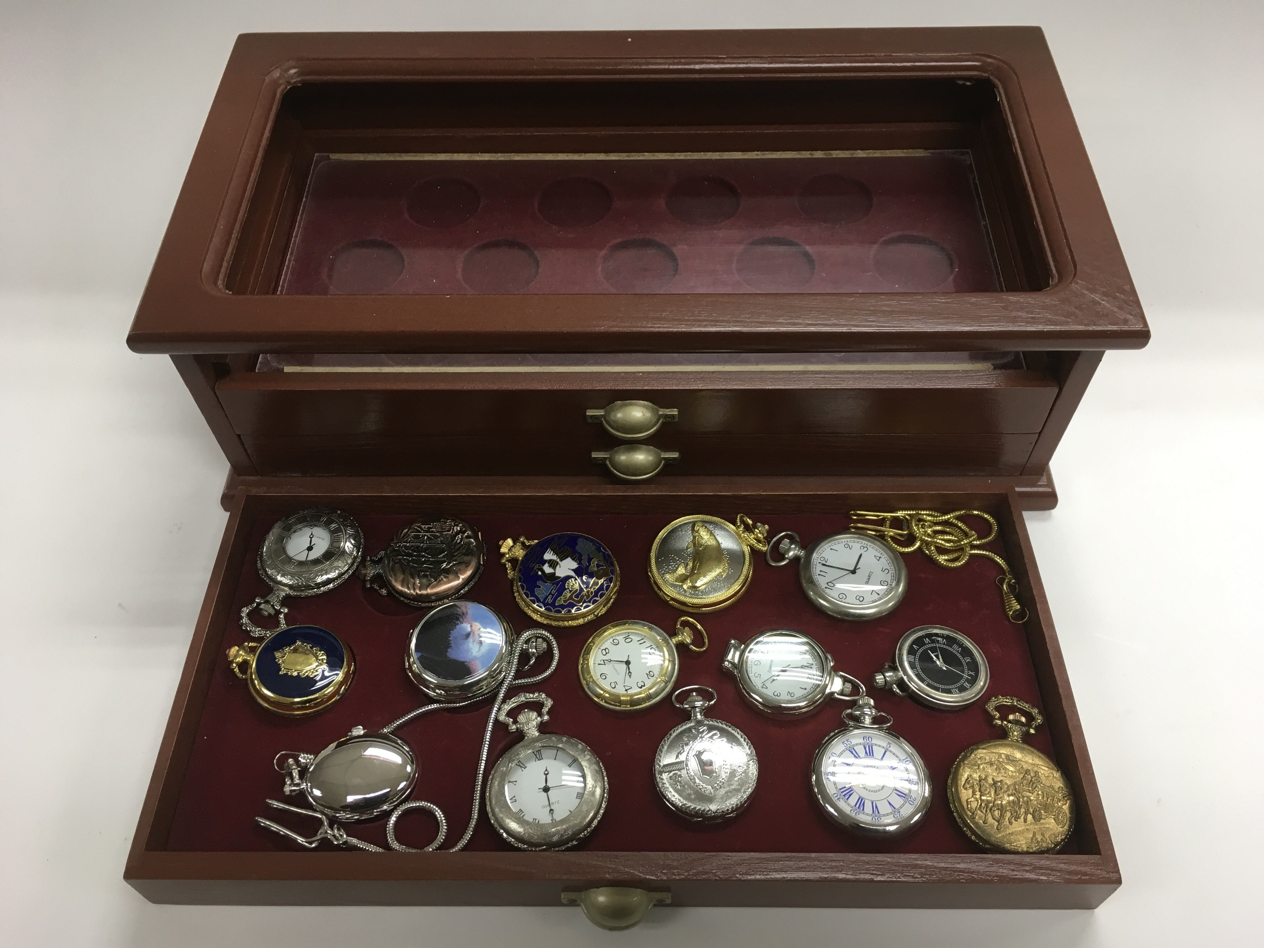 A display case containing various pocket watches.