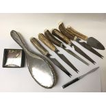 A collection of horn handled knives, a mackintosh