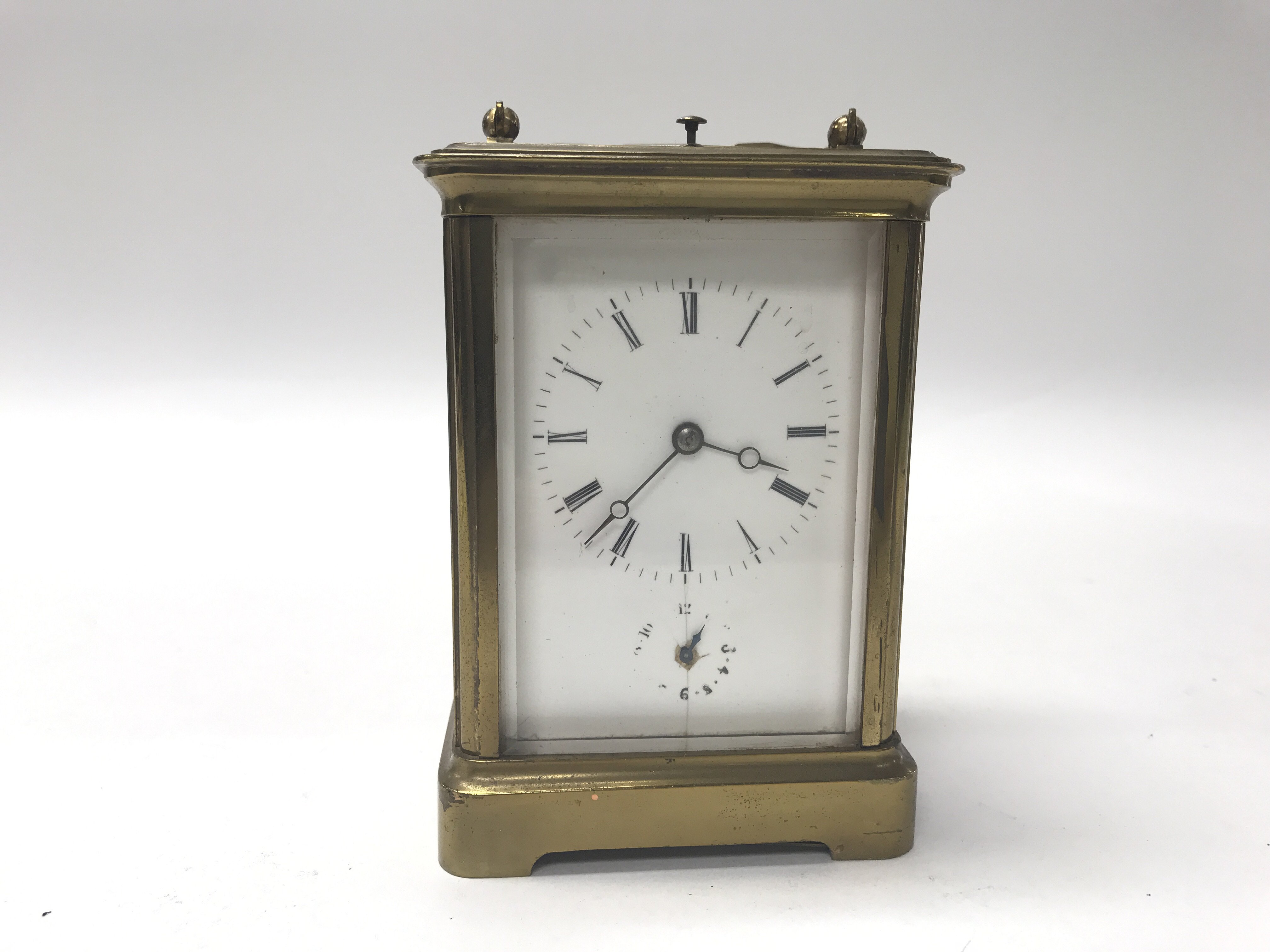 A brass cased repeat carriage clock having Roman n