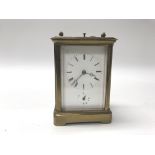 A brass cased repeat carriage clock having Roman n