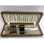 A cased white metal carving set presented by Harri
