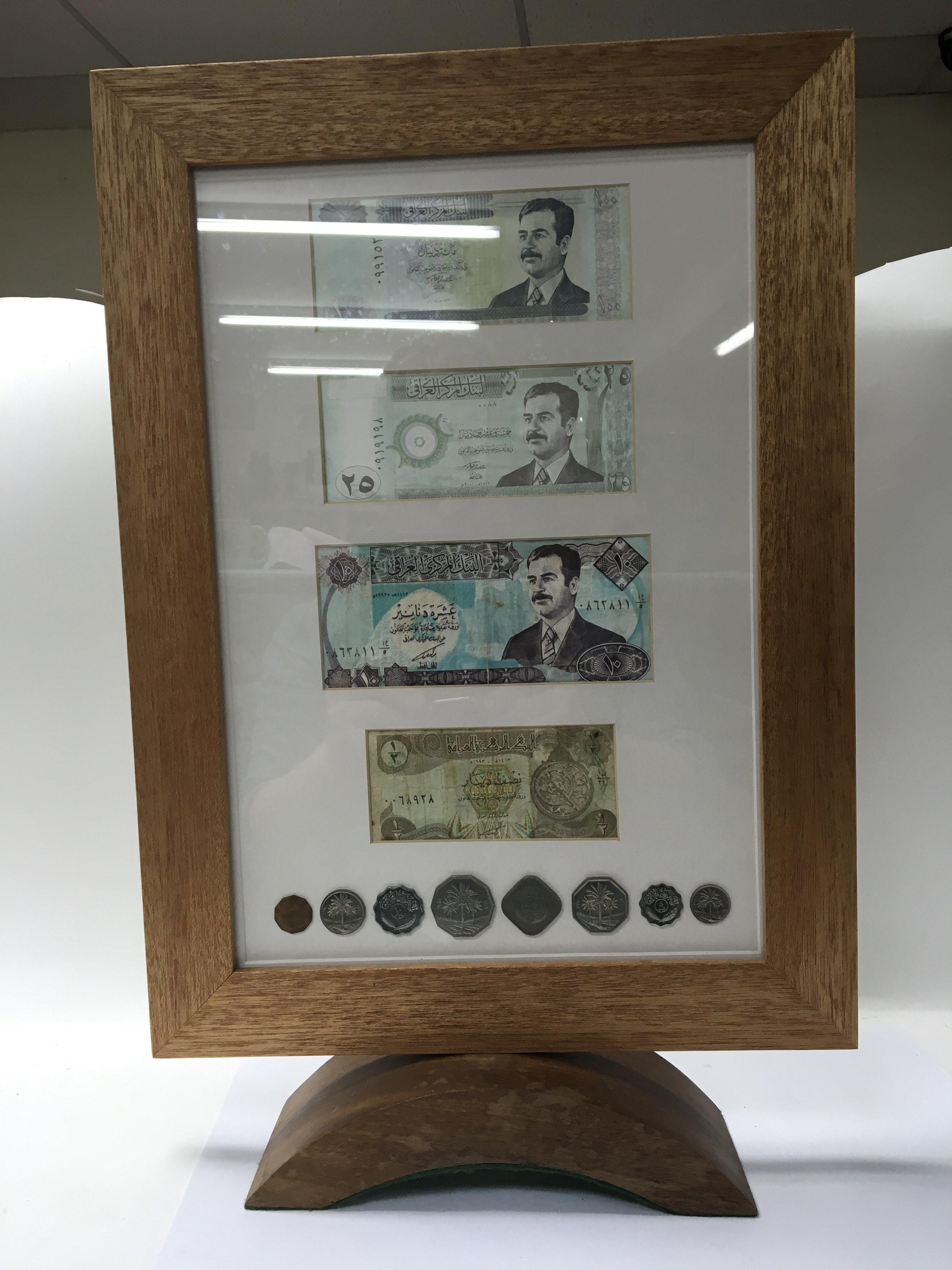 A collection of framed Iranian cash.