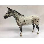A black and white Beswick horse figure, approx hei