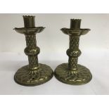 A pair of brass gothic style candle sticks 15 cm