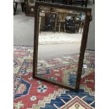 A George II walnut and gilt wood wall mirror of re