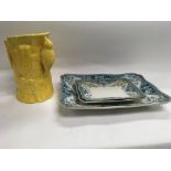 A group of three meat plates and a yellow jug with