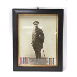 A framed photo of a First World War officer with p