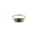 A ladies 18ct gold ring set with a central sapphir