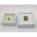 An unmounted tanzanite stone and a mystic topaz (2