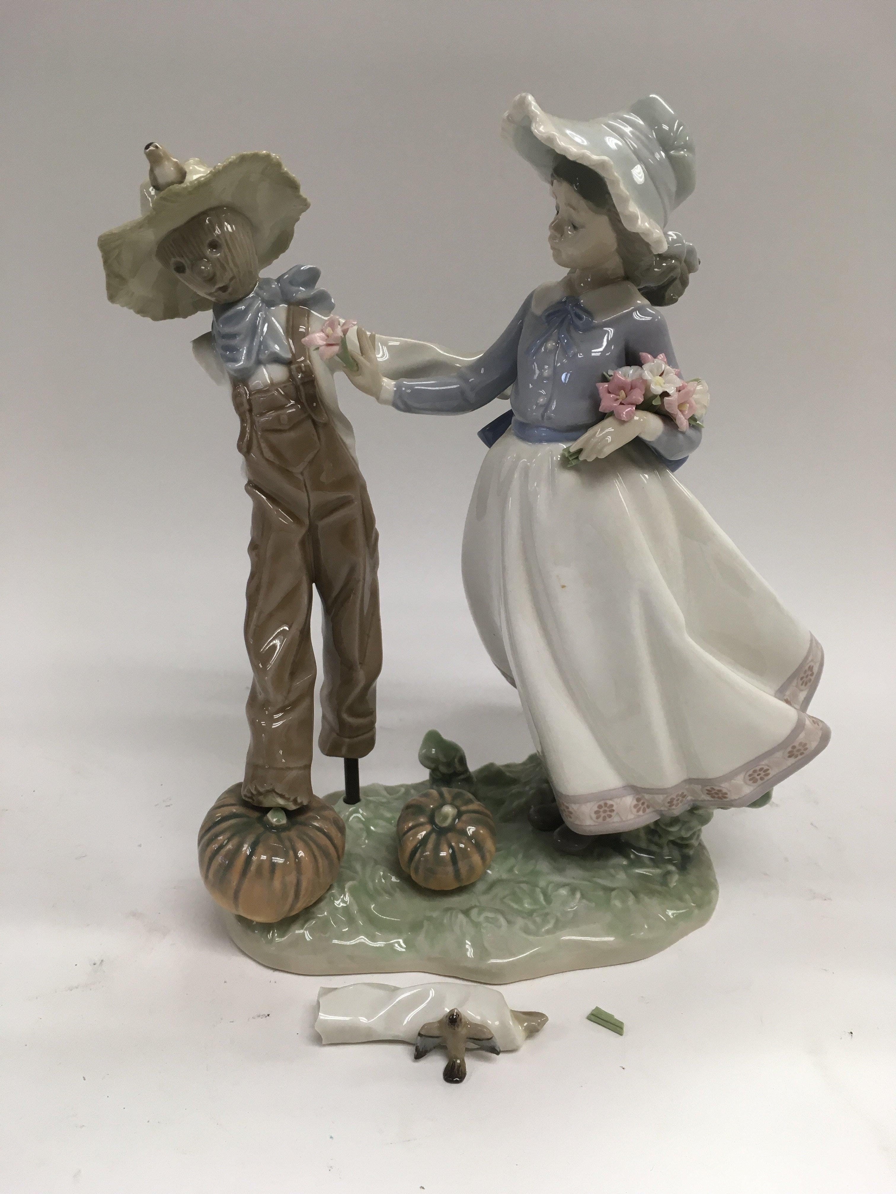 A Lladro figural group of a scarecrow and a girl,