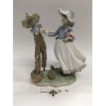 A Lladro figural group of a scarecrow and a girl,