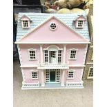 A pink dolls house with lift up roof. Measures app