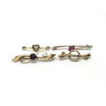 Four gold bar brooches, two set with red stones an
