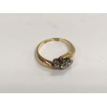 An 18ct gold ring set with three stones, approx 3.