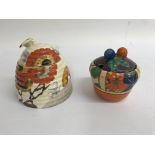 Two Clarice cliff preserve pots decorated with umbrellas and rain hairline crack and