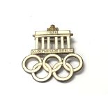 A 1936 Olympic game visitors iron and enamel pin badge.
